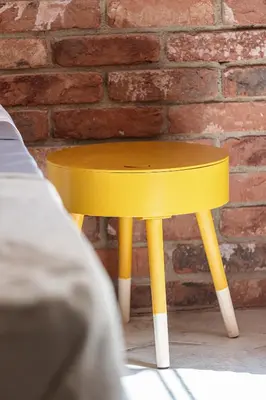 a yellow stool in front of a brick wall at FEEL HOME - BUNICO in Nice