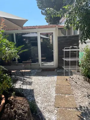 a garden room with a sliding glass door at Cozy house with parking and garden in Nice