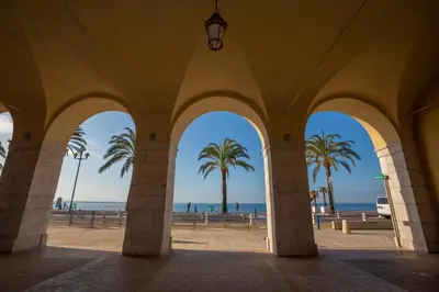 a view of the beach from a building with palm trees at Le Magenta - Happy Rentals in Nice