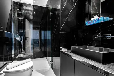 a black bathroom with a sink and a toilet at Le Magenta - Happy Rentals in Nice