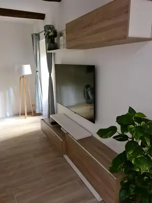 a living room with a tv on a wall at Beautiful Old Town flat, near the beach in Nice