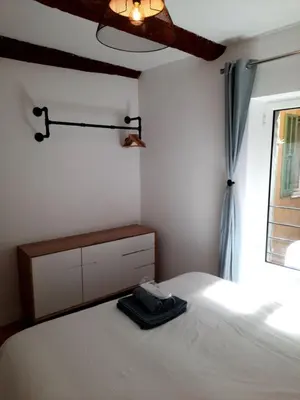 a bedroom with a white bed and a window at Beautiful Old Town flat, near the beach in Nice