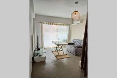 a living room with a couch and a table at Grand Studio avec Coin Nuit et Parking in Saint-Laurent-du-Var