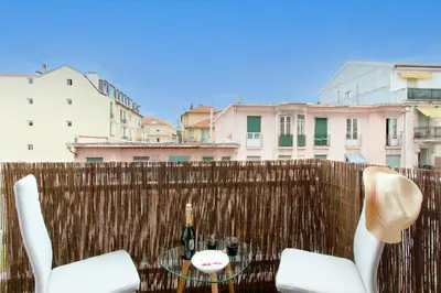 a table and chairs on a fence with a bottle of wine at Maison Bianchi - Herold in Nice