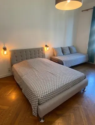 a bedroom with a large bed and a couch at Le Philanthrope - Balcon Wifi Climatisation in Nice