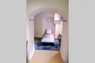a small bedroom with a bed in a hallway at Charming and Modern Cave in the Heart of the Port in Nice