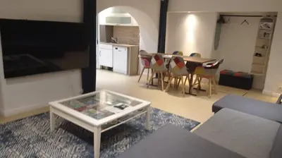 a living room with a couch and a table at Charming and Modern Cave in the Heart of the Port in Nice