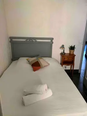 a bed with two towels sitting on top of it at Cosy sweet space in paradise - 5min from the beach in Nice