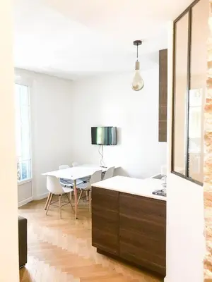 a white room with a table and a dining room at Buffa Résidence in Nice