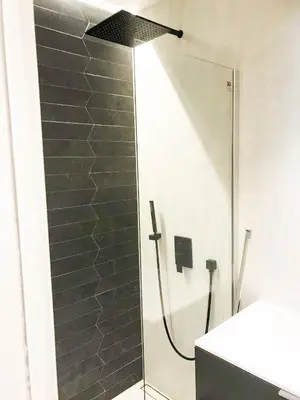 a shower in a bathroom with a glass shower backdoor at Buffa Résidence in Nice