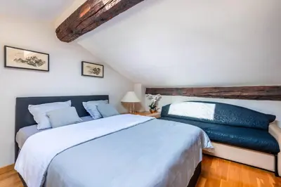 a bedroom with a large white bed with blue pillows at Samourai Massena Lodge -1 min from the sea in Nice