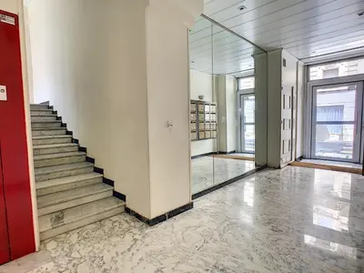 an empty hallway with stairs and a red door at Nestor&Jeeves - ALBERT 1ER DESIGN - Hyper center - Very close sea and pedestrian zone in Nice