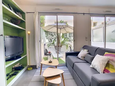 a living room with a couch and a tv at Nestor&Jeeves - BERLIOZ PATIO - Central - Residential area - Patio 20m in Nice