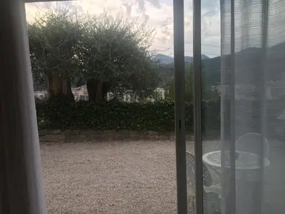 a sliding glass door with a view of a yard at Loft 1 in La Trinité