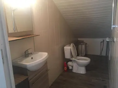 a small bathroom with a sink and a toilet at Loft 1 in La Trinité