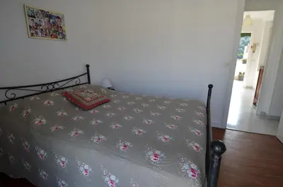 a bedroom with a bed with a gray comforter at PHOENIX - Appartement 4 personnes avec superbe terrasse, clim et parking le port de Nice in Nice