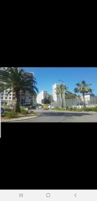 a street with palm trees and buildings in the background at NEW CHEAP PRIVATE ROOM, KITCHEN , OVERWIEUW sea,TRAM on spot, 12 minutes from nice train station with tram , beach in 17 min tram , CHAMBRE PRIVÉE pas cher, cuisine équipée , tram sur place, APERÇU mer, 12 min de la gare de Nice avec le tram, 17 min plage in Nice