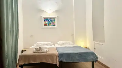 a bedroom with a bed with a towel on it at ApartHotel Riviera - JEAN JAURES 1 - Vieille Ville - Appartement de 3 pieces AC - 100m de la plage in Nice