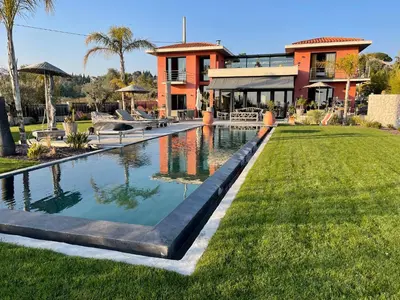 a swimming pool in front of a house at Villa de luxe piscine vue mer in Nice
