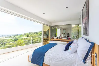 a bedroom with a bed and a large window at VILLA NICE-GAIRAUT by RIVIERA HOLIDAY HOMES in Nice