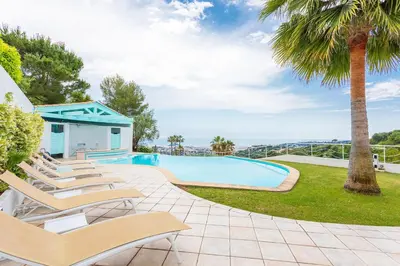 a pool with lounge chairs and a palm tree at VILLA NICE-GAIRAUT by RIVIERA HOLIDAY HOMES in Nice