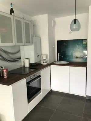 a kitchen with white cabinets and a black and white oven at Appartement à Nice in Nice