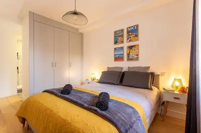 a bedroom with a bed with a yellow blanket on it at JJ8 - MAGNIFIQUE 3PIECES, ENTIEREMENT RENOVE, CLIM, VIEUX-NICE in Nice