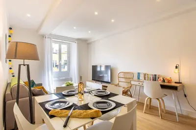 a living room with a table and a dining room at JJ8 - MAGNIFIQUE 3PIECES, ENTIEREMENT RENOVE, CLIM, VIEUX-NICE in Nice
