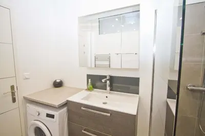 a bathroom with a sink and a washing machine at Florida Sea Front in Nice