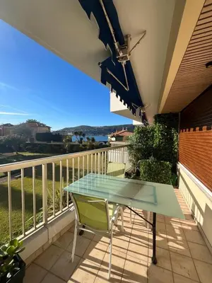 a glass table on the balcony of a house at 3 Piéces confort climatisé vue mer, 4 personnes à Saint-Jean Cap Ferrat à proximité de monaco et menton in Saint-Jean-Cap-Ferrat
