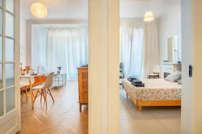 a bedroom and living room with a bed and a table at Stunning flat by the beach, Carre d'or-Negresco in Nice
