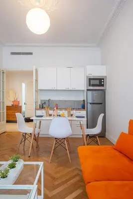 a kitchen and living room with a table and chairs at Stunning flat by the beach, Carre d'or-Negresco in Nice