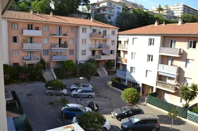 an apartment complex with cars parked in a parking lot at Spacieux/paisible 5 pièces en plein coeur de Nice in Nice