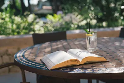 a patio with a table and chairs at Auberge du Rédier - Logis Hôtels in Colomars