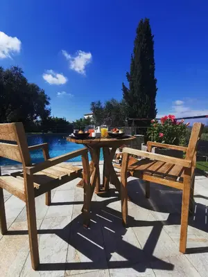 a wooden table and two chairs sitting on a patio at Escondida in Nice