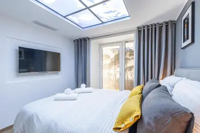 a bedroom with a large white bed with a window at Luxury 3 Bdr Garden & Parking - Angels' Garden in Nice