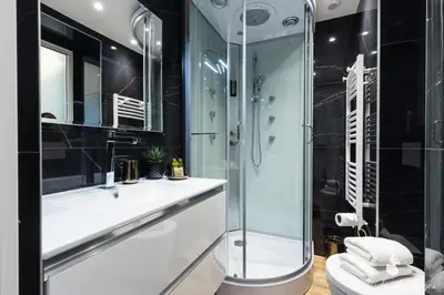 a bathroom with a glass shower and a sink at Luxury 3 Bdr Garden & Parking - Angels' Garden in Nice