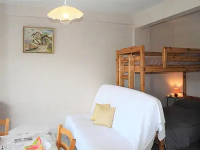 a bedroom with a bed and a bunk bed at Studio Cosy avec Terrasse et Parking, à 30m de la Mer, Cagnes-sur-Mer - FR-1-252A-56 in Cagnes-sur-Mer