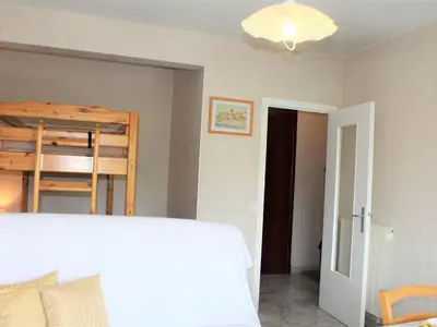 a bedroom with a bed and a bunk bed at Studio Cosy avec Terrasse et Parking, à 30m de la Mer, Cagnes-sur-Mer - FR-1-252A-56 in Cagnes-sur-Mer