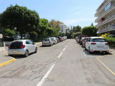 a row of cars parked on the side of a street at Studio Cosy avec Terrasse et Parking, à 30m de la Mer, Cagnes-sur-Mer - FR-1-252A-56 in Cagnes-sur-Mer
