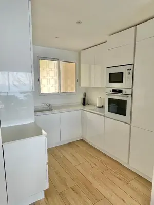 a white kitchen with white cabinets and a window at MyBlueVista LUXURY PANORAMIC SEA VIEW APARTMENTS CAP D AIL NEAR MONACO in Cap d'Ail