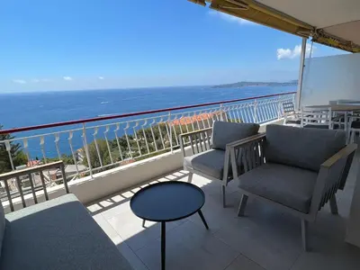a balcony with chairs and a view of the ocean at MyBlueVista LUXURY PANORAMIC SEA VIEW APARTMENTS CAP D AIL NEAR MONACO in Cap d'Ail