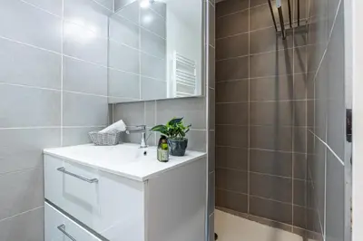 a bathroom with a white sink and a shower at Bright 1 Bdr in the Old Town in Nice