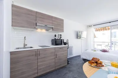 a kitchen with a sink and a table with a bed at MY CASA - GROSSO 4 - Studio with Balcony - Near the Sea in Nice