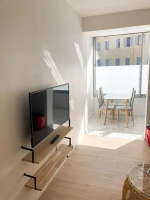 a living room with a flat screen tv on a wall at Halévy Résidence in Nice