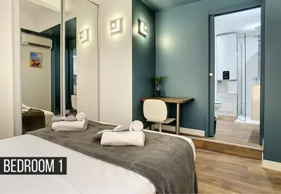 a bedroom with a bed and a table and a chair at Coeur Vieux Nice - Place Rossetti in Nice