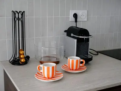 two cups of coffee sitting on a kitchen counter at Ker Riviera in Nice