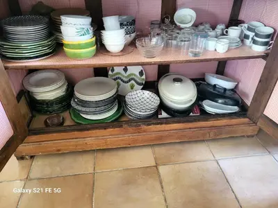 a shelf full of plates and bowls and dishes at Villa les Gabians in Saint-Laurent-du-Var