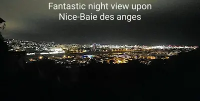 a view of a city at night with lights at Villa les Gabians in Saint-Laurent-du-Var