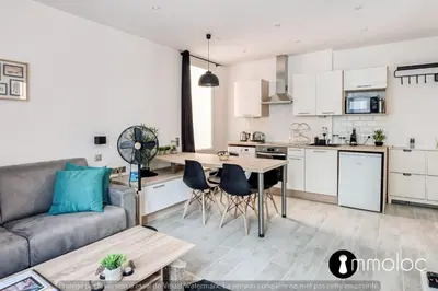 a kitchen and living room with a couch and a table at Hyper central studio 2 minutes walk from 